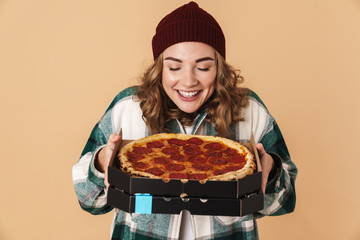 Photo of pretty pleased woman holding box with pizza and smiling