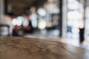 Fototapeta premium Closeup image of a concrete table with blur background in cafe