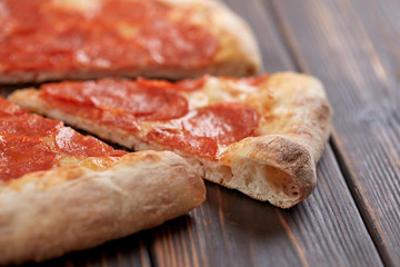 tasty pizza on the wooden background