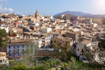 Fototapeta na wymiar Panorama of the old town of Relleu on the Mediterranean coast in the province of Alicante, Spain, tiled roofs of the church dome and beautiful pealms