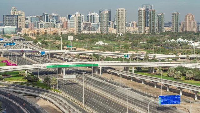 Dubai Golf Course with a cityscape of Gereens and tecom districts at the background aerial timelapse. Traffic on sheikh zayed road with junction
