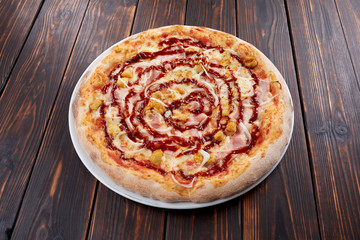 tasty pizza on the wooden background
