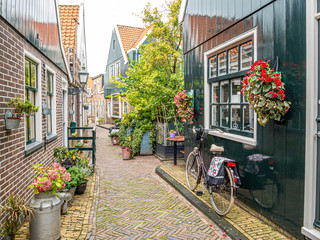 Fototapeta na wymiar Bicycle in small street Kerkepad in Volendam, Noord-Holland, Netherlands