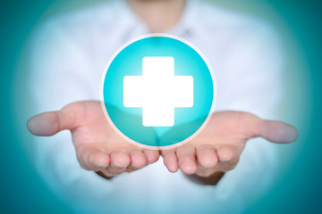 Close-up man in white shirt holding white first aid icon