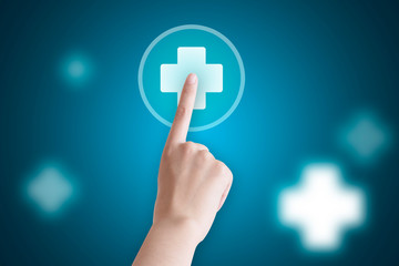 A close-up finger presses the white first aid icon on the screen.