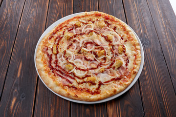 tasty pizza on the wooden background