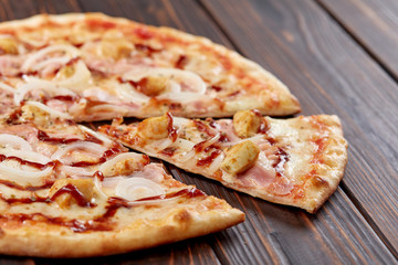 tasty pizza on the wooden background