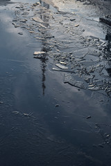 the TV tower is reflected in an icy puddle