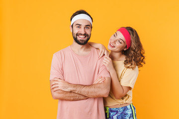 Portrait of athletic young happy couple smiling and standing together