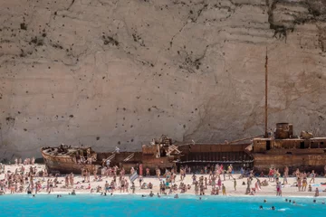 Photo sur Plexiglas Plage de Navagio, Zakynthos, Grèce Navagio, shipwreck beach with white sand, full of tourists bathers in Zante, Zakynthos, Greece