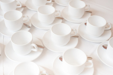 Group of coffee cups in cafe bar on the white tablecloth