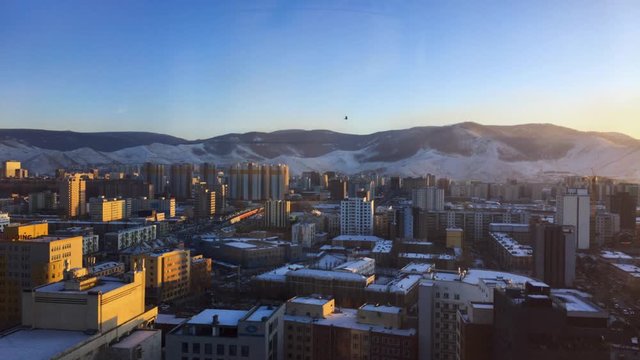 Bird Flying Across Ulaanbaatar, Mongolia Cityscape.  Bogd Khan National Park In Background
