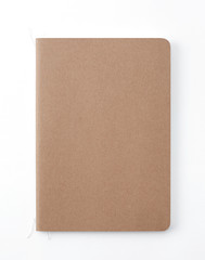 Top view of closed stitch blank recycled paper cover notebook on white background.