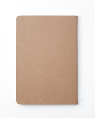 Top view of closed stitch blank recycled paper cover notebook on white background.