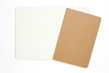 Fototapeta premium Top view of open stitch blank recycled paper cover notebook on white background.