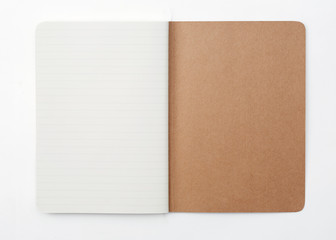 Top view of open stitch blank recycled paper cover notebook on white background.