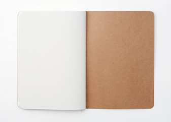 Top view of open stitch blank recycled paper cover notebook on white background.