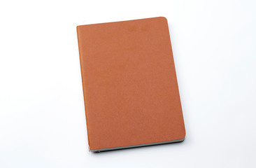 Top view of closed stitch blank recycled paper cover notebook on white background.