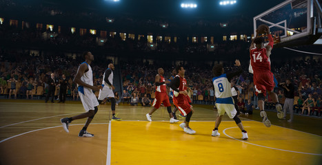 Basketball players on big professional arena during the game. Tense moment of the game. 