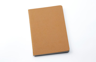 Top view of closed stitch blank recycled paper cover notebook on white background.