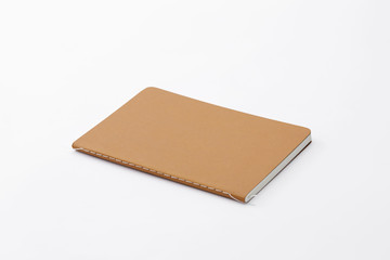 Top view of closed stitch blank recycled paper cover notebook on white background.