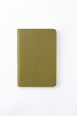 Top view of closed stitch blank recycled paper cover notebook on white background.