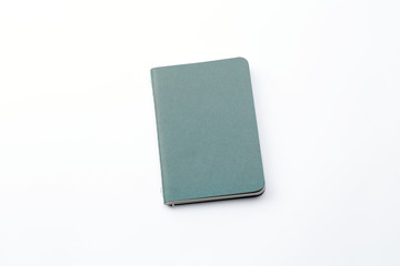 Top view of closed stitch blank recycled paper cover notebook on white background.