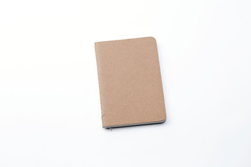 Top view of closed stitch blank recycled paper cover notebook on white background.