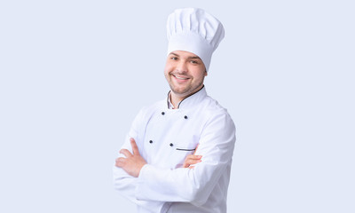 Male Chef Standing Crossing Hands Smiling To Camera, Studio Shot