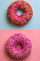 Tasty pink donuts on color background