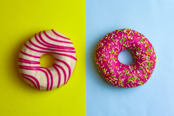 Tasty pink donuts on color background