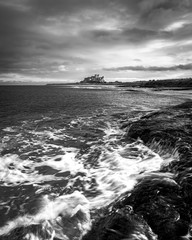 crushing waves across the coastline of northumberland