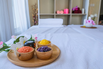 Spa treatment set and aromatic massage oil on bed massage. Thai setting for aroma therapy and massage with flower on the bed, relax and healthy care.