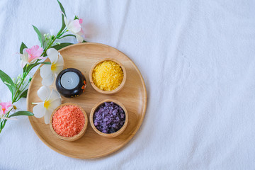Spa treatment set and aromatic massage oil on bed massage. Thai setting for aroma therapy and massage with flower on the bed, relax and healthy care.