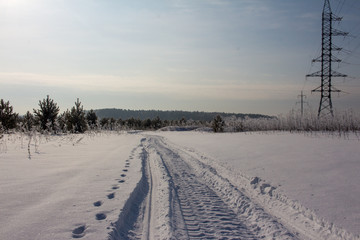 Fototapeta na wymiar snowmobail trail at field covered by snow