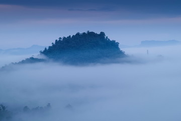 Fototapeta premium view morning of Peak mountain around with sea of mist with cloudy sky background, Khao Sok National Park, Surat Thani, southern Thailand.