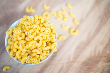 Raw macaroni in a bowl.