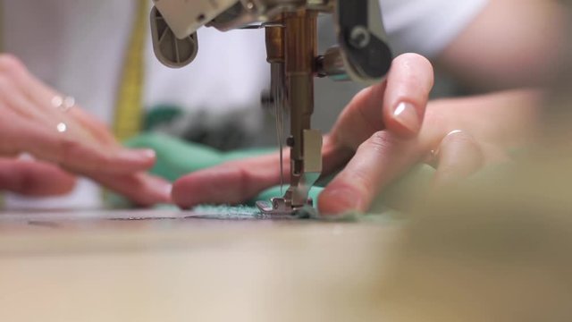 young woman working on sewing machine