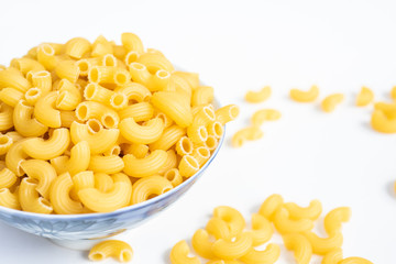 Raw macaroni in a bowl.