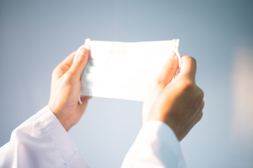Blurred hand scientist with surgical mask.