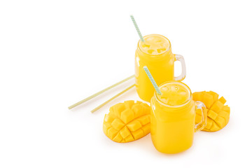 Fresh tropical mango juice with beautiful diced fruit flesh, striped paper straw isolated on white background table, close up, cut out, clipping path.