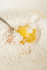 Cooking dough in a white plastic bowl at home