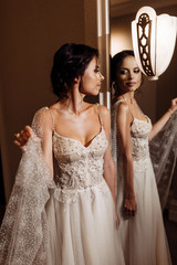 Portrait of beautiful bride with red bouquet in the hall