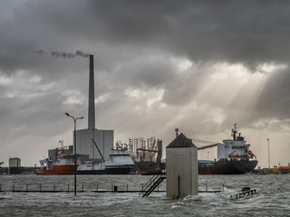 Supply ships for oil and wind power in Esbjerg flooded harbor, Denmark