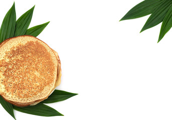 Fototapeta na wymiar Homemade pancakes on white background with green leaves. Maslenitsa, spring festival concept. Russian traditional food. Pancake week. Delicious breakfast. Flat lay style with copy space.