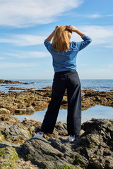 blonde girl watching the sea