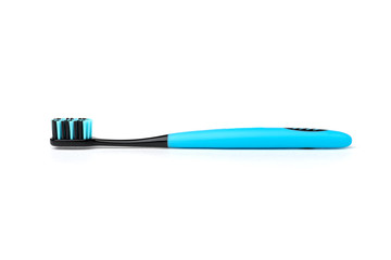 Blue toothbrush with black bristles isolated on white background.