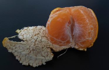 Clos-up orange peeled by hand, placing orange on the floor. Healthy fresh orange.Design isolated on...