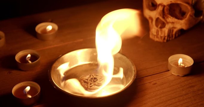 Burning pentacle on altar closeup footage