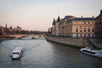 Fototapeta na wymiar The ship sails along the River Seine in Paris, France. A warm summer evening in Paris.